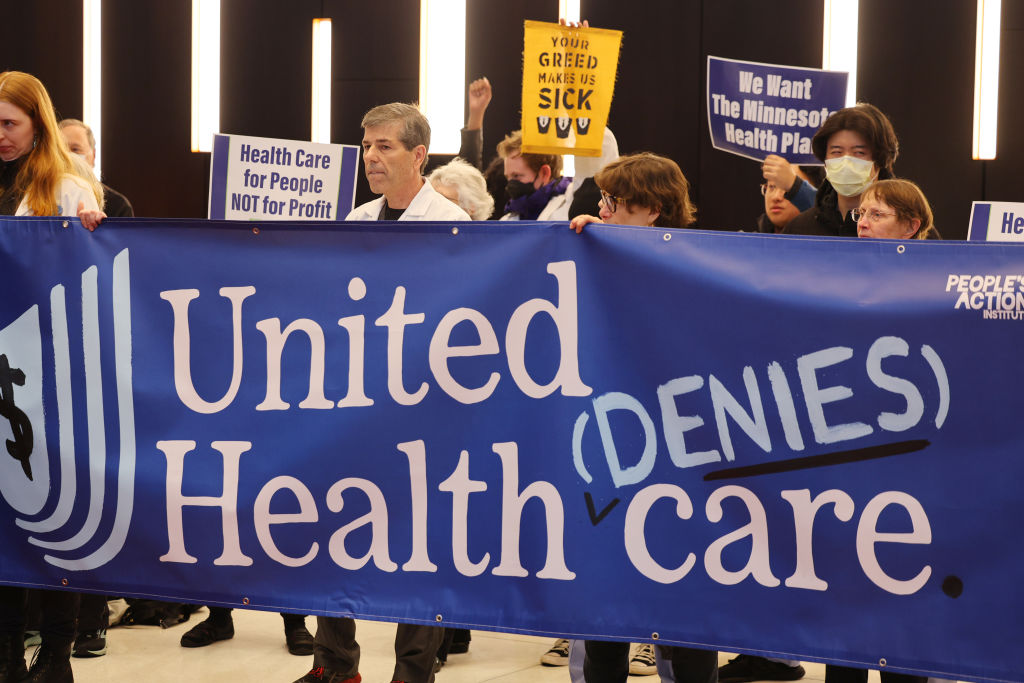 EDEN PRAIRIE, MINNESOTA - APRIL 16: Protesters with People's Action target health insurance giant UnitedHealth Group due to exorbitant health insurance costs and insurance claims denials on April 16, 2024 in Eden Prairie, Minnesota. (Photo by Adam Bettcher/Getty Images for People's Action Institute)